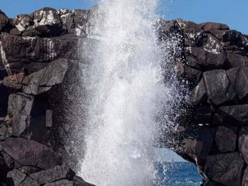 A natural blowhole spraying water on the coast of San Cristóbal