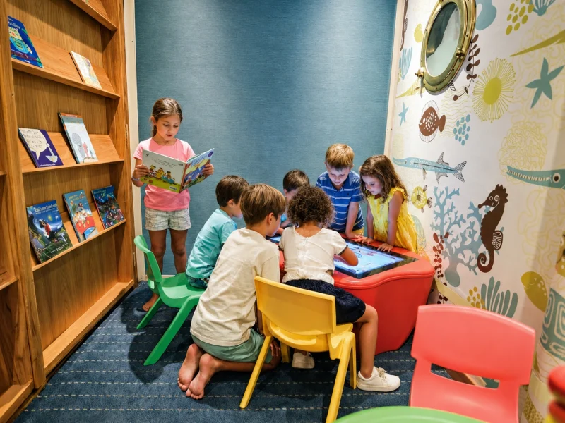 Children reading and playing in the Kid's Corner aboard Galápagos Legend
