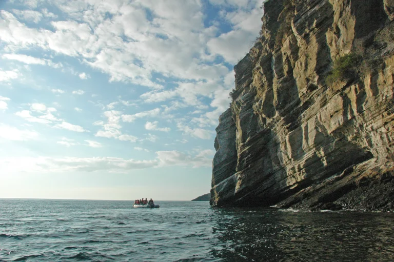 Guests exploring the cliffs of Tagus Cove by panga, Isabela Island